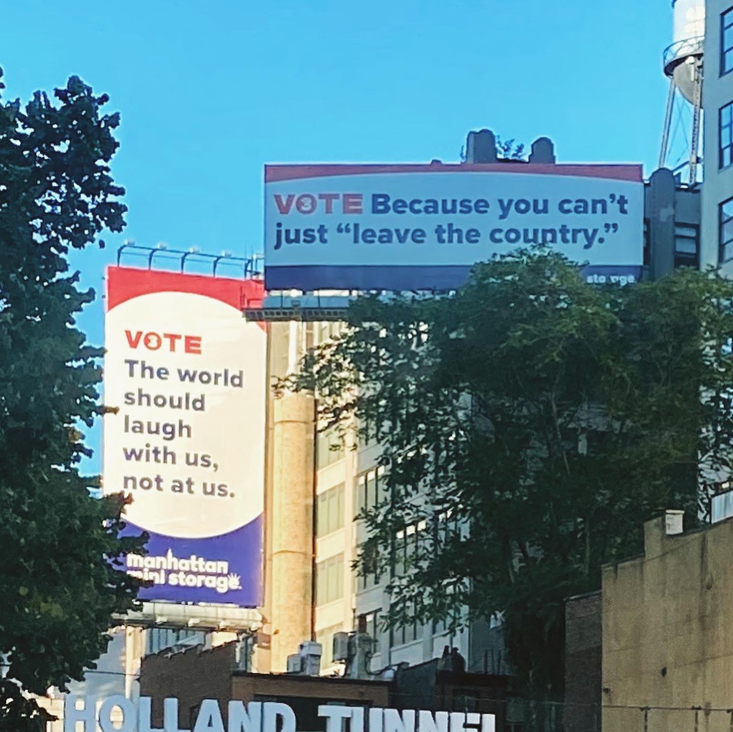 Manhattan Mini Storage Vote Campaign billboards near Holland Tunnel — 'VOTE The world should laugh with us, not at us' and 'VOTE Because you can't just leave the country'